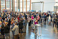 Participants stand in the entrance hall of the Estoril Convention Centre during the break