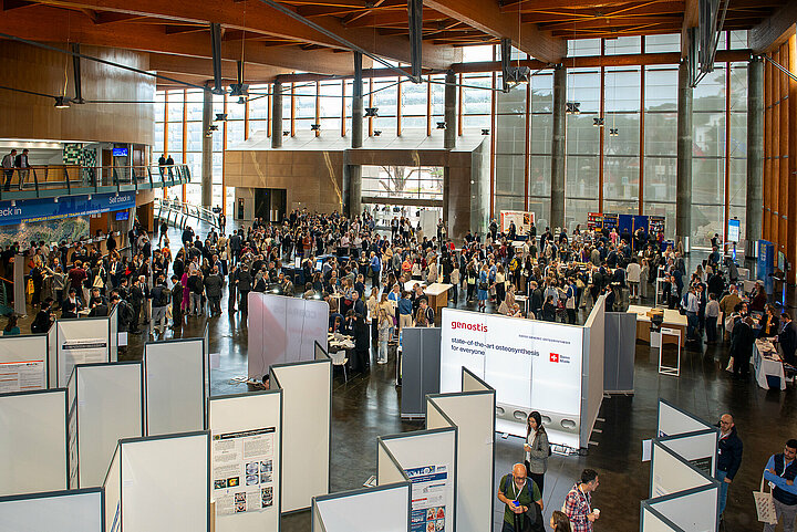 Participants stand in the entrance hall of the Estoril Convention Centre during the industry exhibition