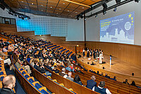 Participants listen to an artistic contribution in the lecture theatre